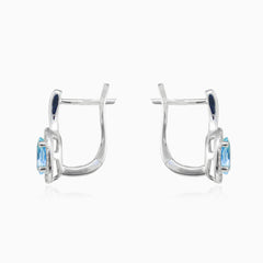 White gold earrings with blue topaz and diamond halo design