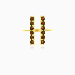 Gold ring with garnets along finger