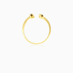 Gold ring with garnets along finger