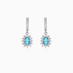 Halo silver dangling earrings with blue topaz