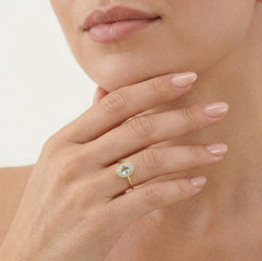 Oval topaz halo gold ring