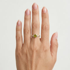 Stylish gold ring with moldavite and cubic zirconia