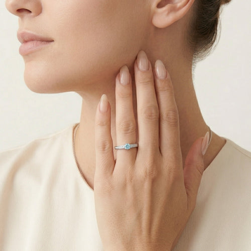 Elegant white gold ring with diamond and blue topaz