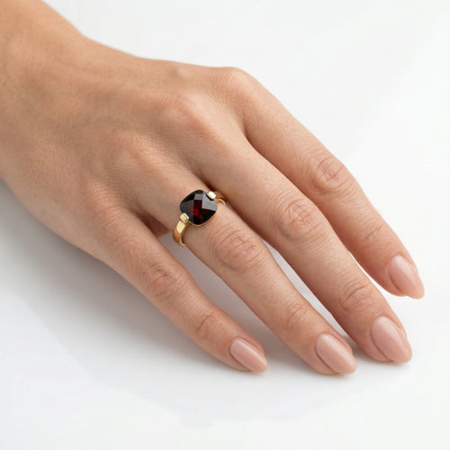Garnet cushion cut in bar setting