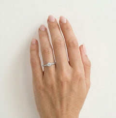 White gold ring with exposed cubic zirconia and side zircons