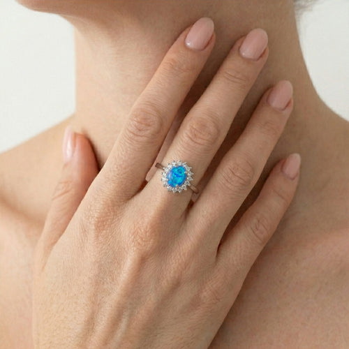 Sterling silver halo ring with blue opal
