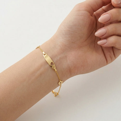 Pulsera de oro con detalles de flores y placa central