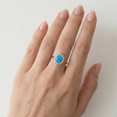 Sterling silver halo ring with blue opal