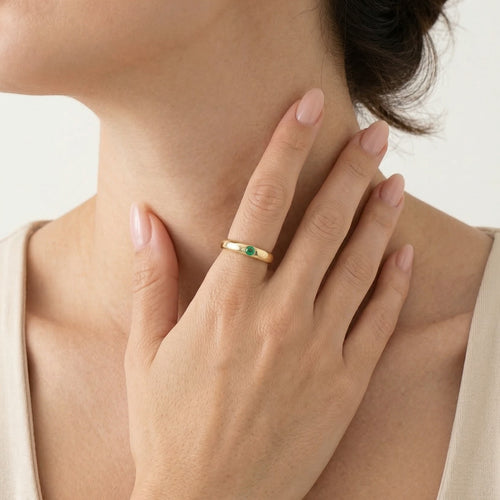 Simple gold ring with small emerald