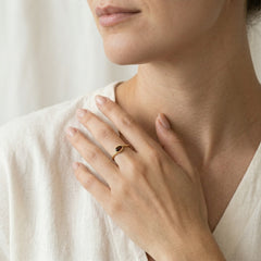 Oval cut garnet ring in semi bezel setting