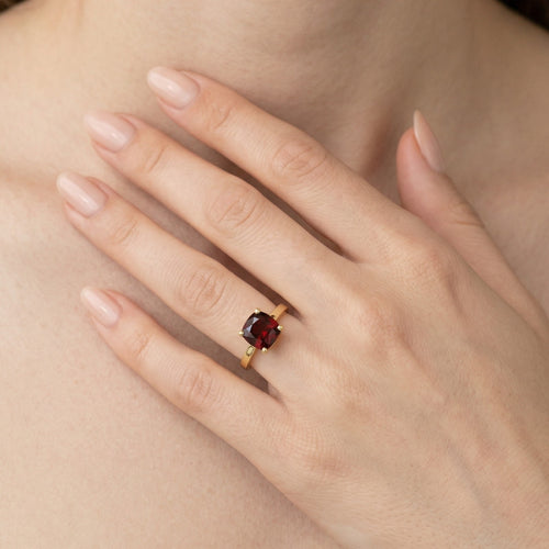 Garnet cushion cut in prong setting