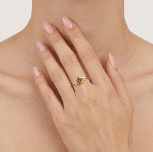 Stylish gold ring with moldavite and cubic zirconia