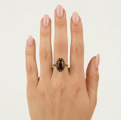 Elegant oval and round garnet ring