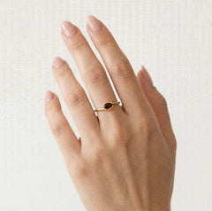 Oval cut garnet ring in semi bezel setting