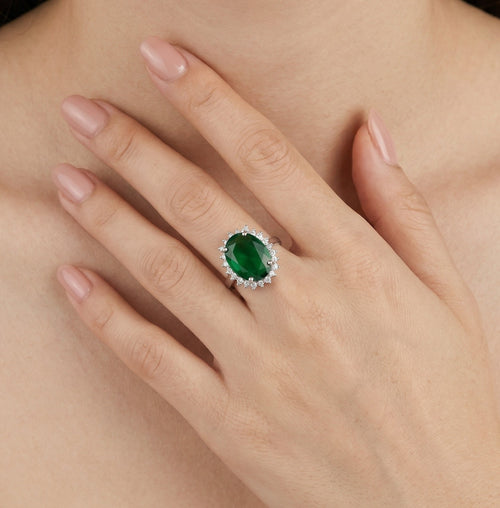 Halo sterling silver ring with oval emerald