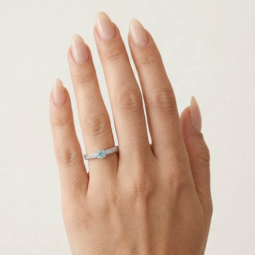 Elegant white gold ring with diamond and blue topaz
