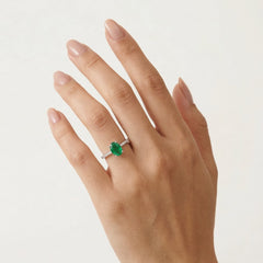 White gold ring with oval emerald and diamonds