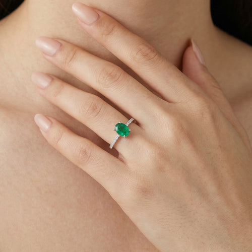 White gold ring with oval emerald and diamonds
