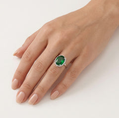 Halo sterling silver ring with oval emerald