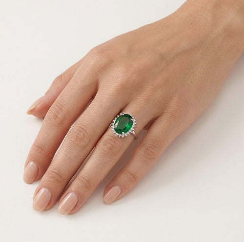 Halo sterling silver ring with oval emerald