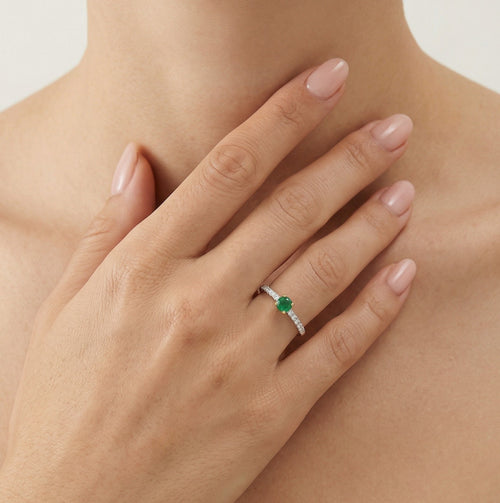 Elegant round cut emerald and diamond ring