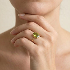 Oval moldavite gold ring with ten prongs