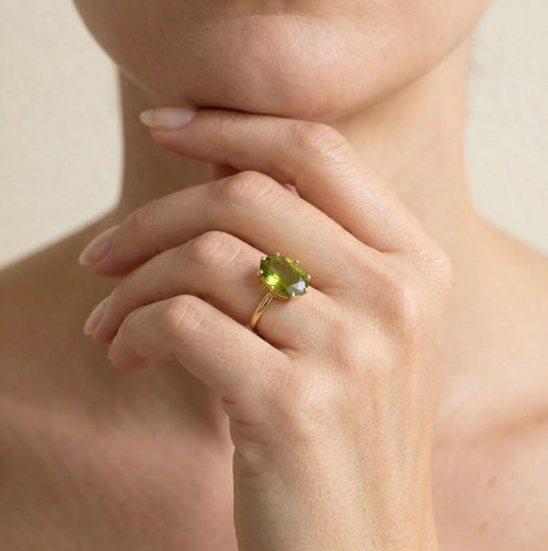 Oval moldavite gold ring with ten prongs