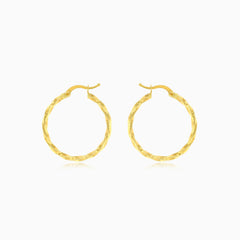 Yellow gold twist polished hoop earring
