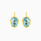Boucles d’oreilles en or avec topaze bleue ovale