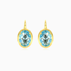 Boucles d’oreilles en or avec topaze bleue ovale