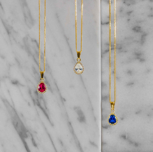 Péndulo de rubí en corte pera y oro amarillo