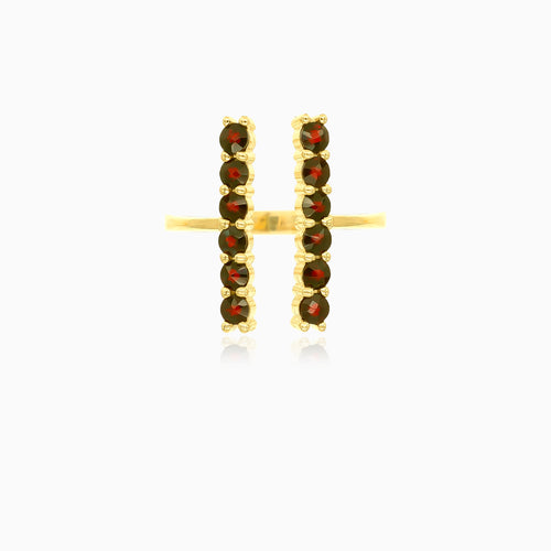 Gold ring with garnets along finger