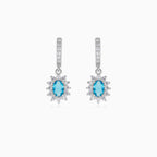 Halo silver dangling earrings with blue topaz