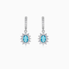 Halo silver dangling earrings with blue topaz