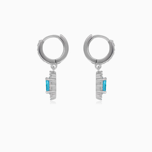 Halo silver dangling earrings with blue topaz