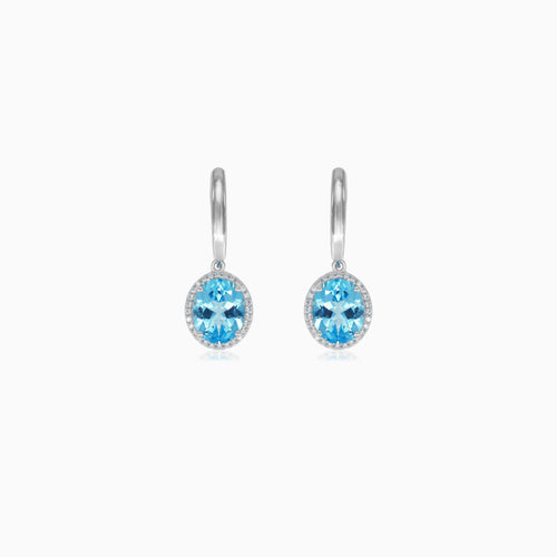 Halo sterling silver dangling earrings with blue topaz