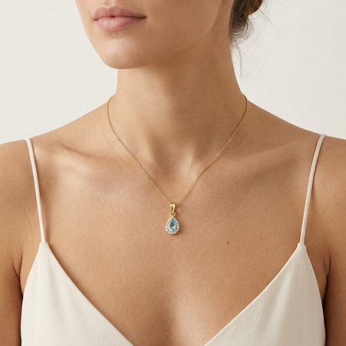 Blue topaz and cubic zirconia halo gold pendant