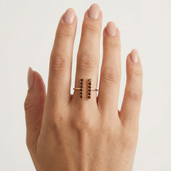 Gold ring with garnets along finger