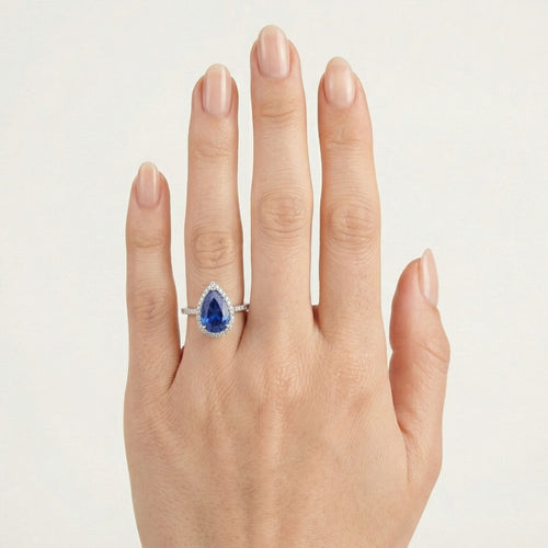 Halo-Ring aus Sterlingsilber mit tropfenförmigem Saphir