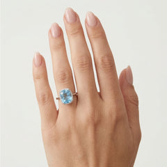 Bright white gold ring with topaz and diamonds