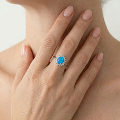 Sterling silver halo ring with blue opal