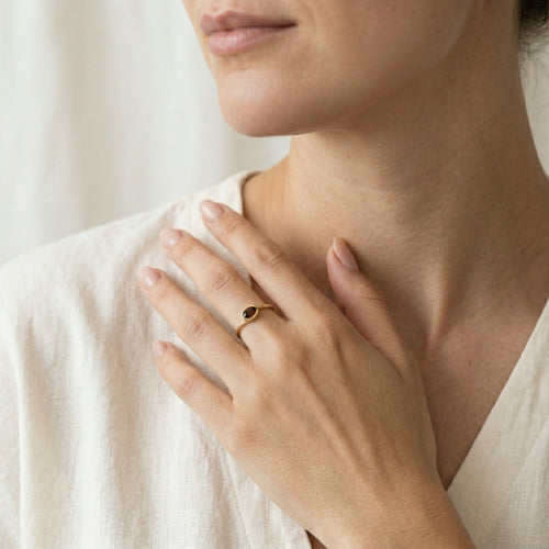 Oval cut garnet ring in semi bezel setting