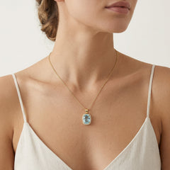 Yellow gold cushion cut blue topaz halo pendant