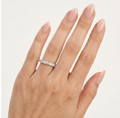 Anillo de boda de oro blanco con piedras en la mitad del aro.