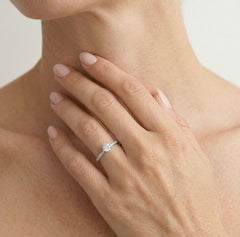 White gold ring with exposed cubic zirconia and side zircons