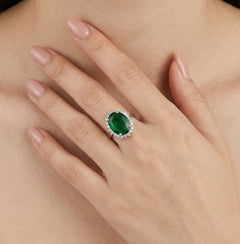 Halo sterling silver ring with oval emerald