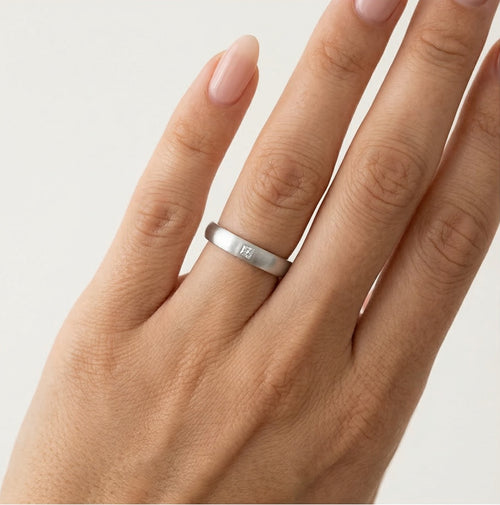 Anillo de boda de oro blanco con acabado mate y piedra de talla princesa