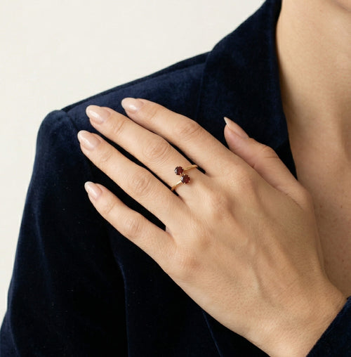 Yellow gold ring with two garnet balls