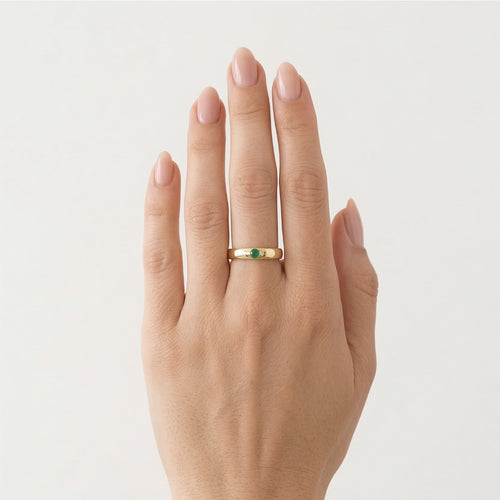 Simple gold ring with small emerald