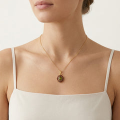 Himmlische Harmonie Anhänger in Gelbgold mit ovalem Moldavit und rundem Granat